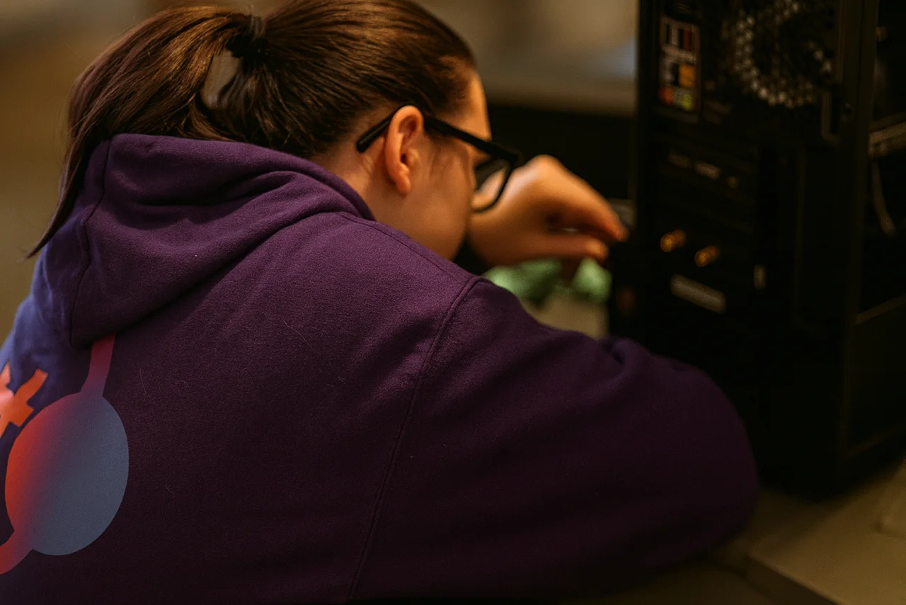 A Brotherly Technology technician working inside a desktop PC